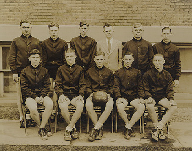 Members of the team stand and sit in two rows for the photo.