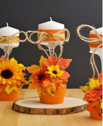 a wine glass that is glued to a wood coaster upside down and a candle ontop. Fall items added as decor