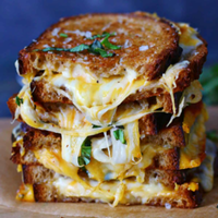 Grilled cheese sandwiches stacked on one another.