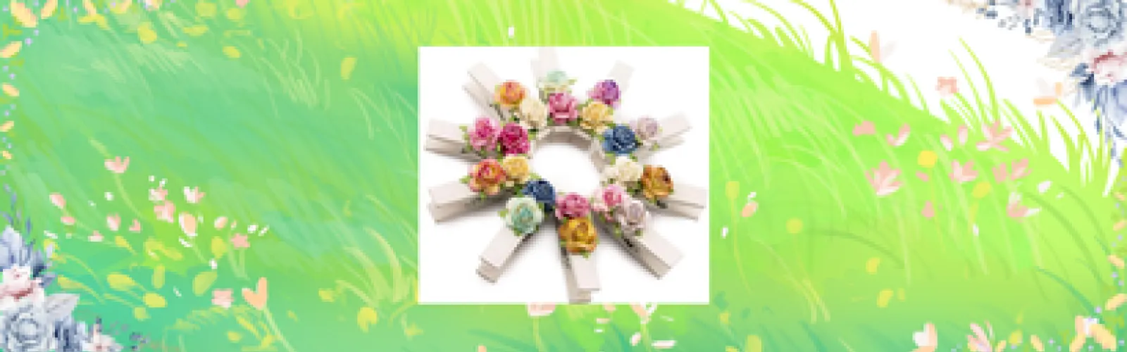 A wreath made of clothespins overtop a grassy field with a flowered border.