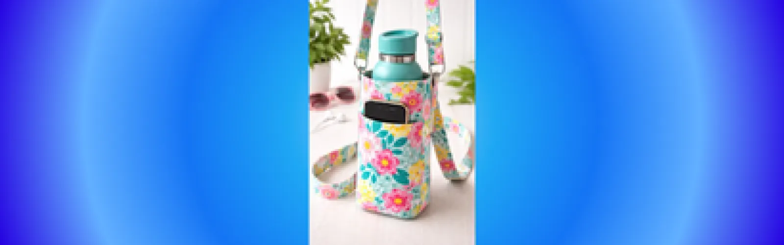 A water bottle and phone sit in a fabric cozy before a blue background.