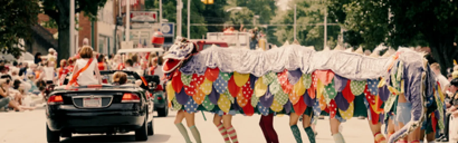 a group of people walking down the street in a parade