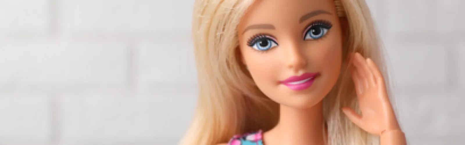A close up of a Barbie doll's face.